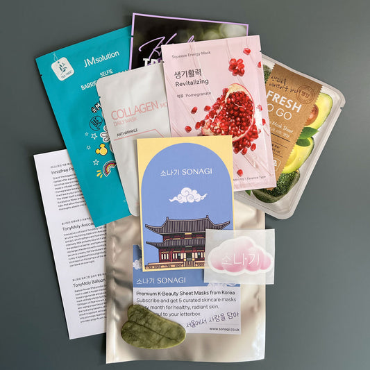 Korean sheet mask box containing 5 sheet masks, a quartz jade Gua Sha, and a sticker