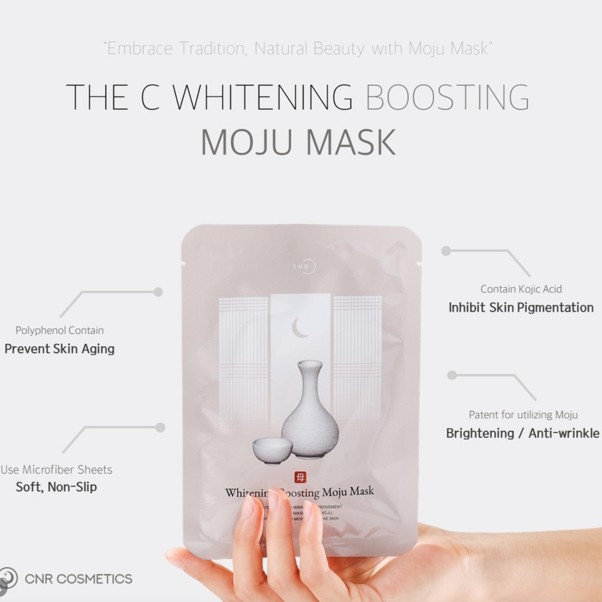 A hand holds a silver C Whitening Boosting Moju Mask pouch against a light gray background with feature callouts and CNR Cosmetics branding.